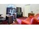 Home office space with a computer setup and a red couch at 13400 Norman Cir, Hudson, FL 34669