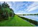 Backyard with lush landscaping and a lake view at 331 Star Shell Dr, Apollo Beach, FL 33572