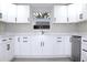 Modern kitchen with white shaker cabinets and quartz countertops at 3010 E 149Th Ave, Lutz, FL 33559