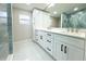 Elegant bathroom with a double vanity and a large shower at 3010 E 149Th Ave, Lutz, FL 33559