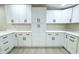 Modern kitchen with white cabinets and ample storage space at 3010 E 149Th Ave, Lutz, FL 33559