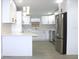 Modern kitchen with white shaker cabinets and stainless steel appliances at 3010 E 149Th Ave, Lutz, FL 33559