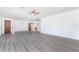 Spacious living room with gray laminate wood flooring and ceiling fan at 29171 Orva Dr, Punta Gorda, FL 33982