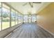 Spacious Florida room with wood-look floors and large windows at 29171 Orva Dr, Punta Gorda, FL 33982