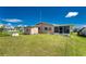 Back exterior view showing shed and screened porch at 29171 Orva Dr, Punta Gorda, FL 33982