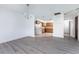 Open dining room with wood-look floors and kitchen access at 29171 Orva Dr, Punta Gorda, FL 33982
