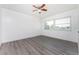 Well-lit bedroom with wood-look floors and a large window at 29171 Orva Dr, Punta Gorda, FL 33982