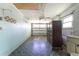 Attached garage with tiled floor and storage cabinet at 29171 Orva Dr, Punta Gorda, FL 33982