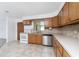 Bright kitchen featuring wood cabinets, stainless steel appliances, and tile floors at 29171 Orva Dr, Punta Gorda, FL 33982