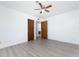 Bright bedroom with wood-look floors and ceiling fan at 29171 Orva Dr, Punta Gorda, FL 33982