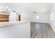 Spacious living room with grey vinyl flooring and kitchen view at 29171 Orva Dr, Punta Gorda, FL 33982