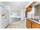 Kitchen with wood cabinets, tiled floor and view of living room at 29171 Orva Dr, Punta Gorda, FL 33982