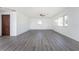 Bright and airy living room with gray laminate flooring and large windows at 29171 Orva Dr, Punta Gorda, FL 33982