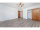 Spacious bedroom with wood-look floors and ceiling fan at 29171 Orva Dr, Punta Gorda, FL 33982