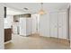 Kitchen with dark cabinets, white appliances, and access to dining area at 7015 Flaggler Dr, Port Richey, FL 34668