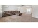 Spacious living room with a large sectional sofa and carpet at 7015 Flaggler Dr, Port Richey, FL 34668