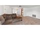 Living room features carpet, sectional sofa, and access to sunroom at 7015 Flaggler Dr, Port Richey, FL 34668