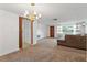 Dining room with chandelier and access to living room and kitchen at 7015 Flaggler Dr, Port Richey, FL 34668
