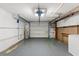 Garage with overhead door, extra storage, and workbench at 7015 Flaggler Dr, Port Richey, FL 34668