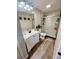 Clean bathroom with white vanity, shower stall, and wood-look flooring at 10200 Gandy Blvd # 1116, St Petersburg, FL 33702