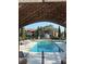 Refreshing community pool with surrounding lounge chairs and brick pergola at 10200 Gandy Blvd # 1116, St Petersburg, FL 33702
