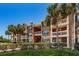 Brick apartment building with lush landscaping and palm trees at 10200 Gandy Blvd # 1116, St Petersburg, FL 33702