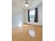 Bedroom with laminate floor and window with decorative dark curtains at 761 Tremont Greens Ln # 61, Sun City Center, FL 33573