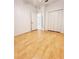 Spacious bedroom with wood-look floors, closet, and entry door at 761 Tremont Greens Ln # 61, Sun City Center, FL 33573