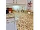 Detailed view of granite countertops with stylish decor and ample space in the kitchen at 761 Tremont Greens Ln # 61, Sun City Center, FL 33573