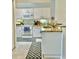 Cozy kitchen with white cabinets, neutral granite countertops, and modern appliances at 761 Tremont Greens Ln # 61, Sun City Center, FL 33573