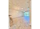 Open-concept living room with large sliding glass doors and a modern chandelier at 761 Tremont Greens Ln # 61, Sun City Center, FL 33573