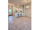 Spacious living room with tile floors, stylish lighting, and open access to the kitchen at 761 Tremont Greens Ln # 61, Sun City Center, FL 33573