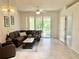 Comfortable living room with a brown sectional sofa, a coffee table, and a view of the outdoors at 761 Tremont Greens Ln # 61, Sun City Center, FL 33573