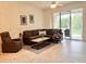 Inviting living room with a plush sectional sofa and natural light streaming through sliding glass doors at 761 Tremont Greens Ln # 61, Sun City Center, FL 33573