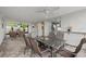Relaxing patio features wicker furniture, ceiling fan, and screened enclosure at 2707 W Leroy St, Tampa, FL 33607
