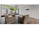 Screened patio with wicker furniture and view of tropical landscaping at 2707 W Leroy St, Tampa, FL 33607