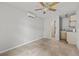 Bedroom with tiled floor, ceiling fan, and access to a bathroom and kitchenette at 2707 W Leroy St, Tampa, FL 33607
