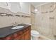 Bathroom with walk-in shower, vanity, and toilet at 2707 W Leroy St, Tampa, FL 33607