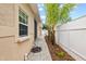 Landscaped side yard with paver walkway and fence at 2707 W Leroy St, Tampa, FL 33607