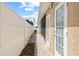 Landscaped side yard with paver walkway and fence at 2707 W Leroy St, Tampa, FL 33607