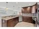 Updated kitchen, featuring dark wood cabinets and granite countertops at 2707 W Leroy St, Tampa, FL 33607