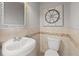Small bathroom with pedestal sink, toilet, and nautical-themed decor at 2707 W Leroy St, Tampa, FL 33607