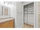 Bathroom with wood vanity, granite countertop and walk-in closet at 2707 W Leroy St, Tampa, FL 33607