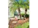 Landscaped front yard with palm trees and a garden flag at 761 Tremont Greens Ln # 61, Sun City Center, FL 33573