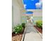 White metal gate leading to a paved walkway at 761 Tremont Greens Ln # 61, Sun City Center, FL 33573