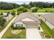 Aerial view of a one-story house with a landscaped yard at 12202 Miracle Mile Dr, Riverview, FL 33578