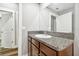 Simple bathroom with granite countertop and brown vanity at 12202 Miracle Mile Dr, Riverview, FL 33578