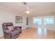 Relaxing living room with hardwood floors, ceiling fan, and ample natural light at 4961 Grist Mill Cir, New Port Richey, FL 34655