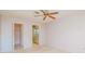 Bright bedroom with ceiling fan and access to bathroom and closet at 4961 Grist Mill Cir, New Port Richey, FL 34655