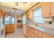 Updated kitchen with light wood cabinets, ample counter space, and a window overlooking the backyard at 4961 Grist Mill Cir, New Port Richey, FL 34655
